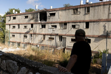 KIRYAT SHMONA, ISRAEL - NOVEMBER 20: A man inspects a damaged building after a rocket was fired from Lebanon in the northern city on 20/11/2024 in Kiryat Shmona, Israel. Israeli Army Radio reported that a rocket fired from Lebanon crashed into the building this morning. (Photo by Amir Levy/Getty Images)