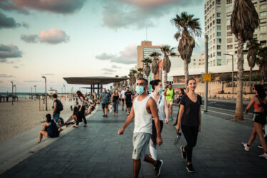 Tel Aviv Israel 04/10/2020 View of unidentified people without a face mask to protect themself walking on Herbert Samuel Promenade in Tel Aviv during lockdown and Coronavirus outbreak