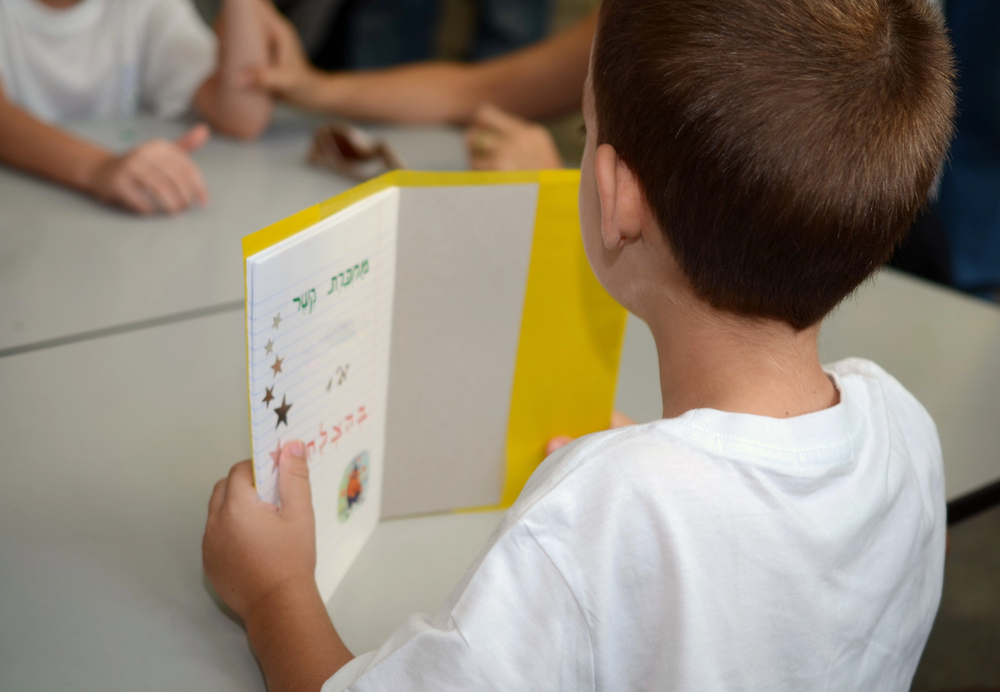A child reading a book in school