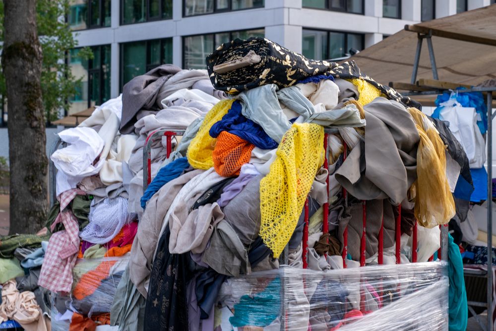 Pile of old clothes dumped in a container
