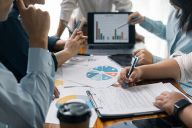 Financial analyst presented a detailed data analysis graph to their colleague, corporate office, demonstrating the business's financial status and trends. Concept of business data analysis.