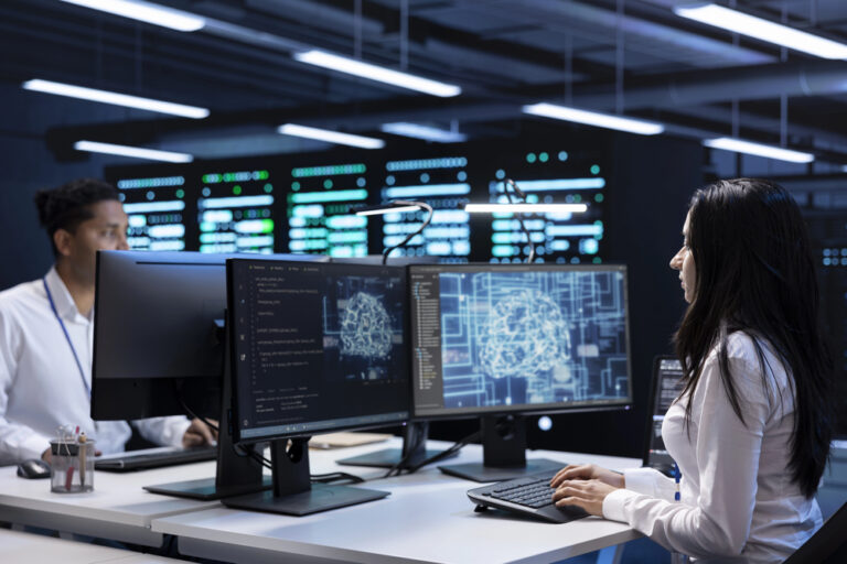 Team of experts working on PC in data center with artificial intelligence tech