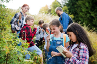 Group of school children with teacher on field